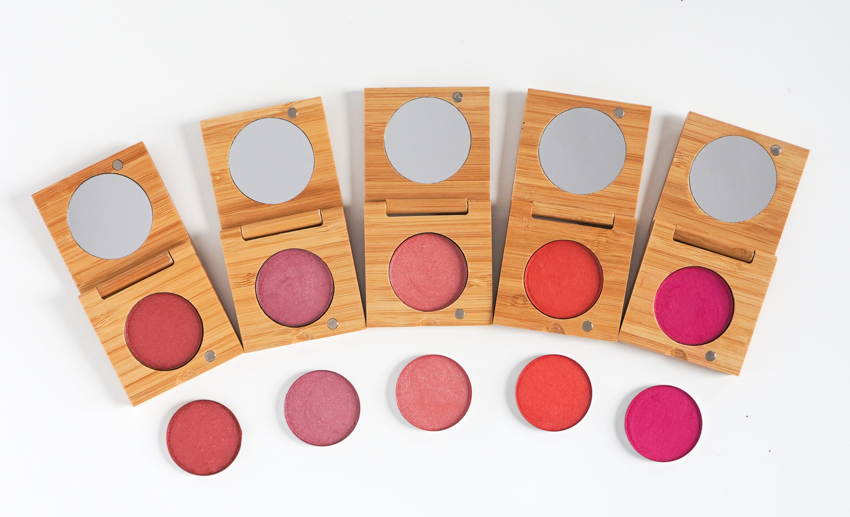 Five shades of pressed blush in refillable bamboo compacts with refills